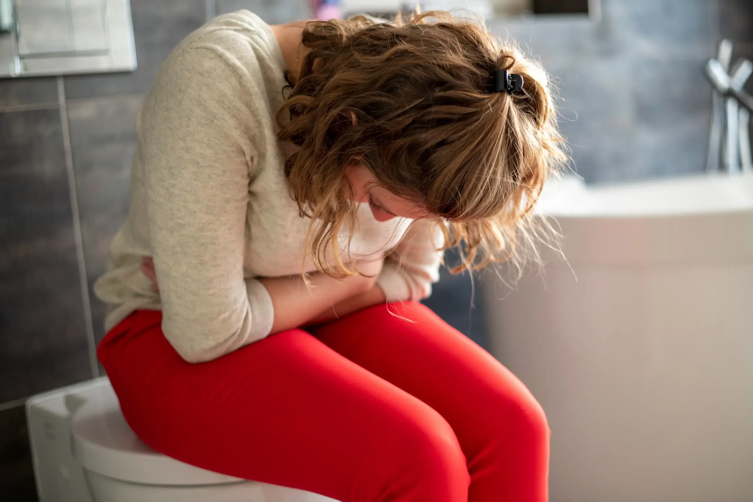 woman sitting on the toilet with a head ache and c 2024 03 01 15 36 37 utc 1 scaled